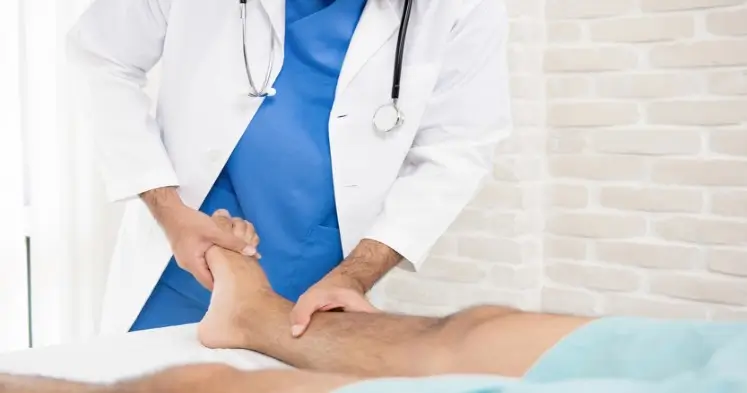 Doctor examining leg for varicose veins